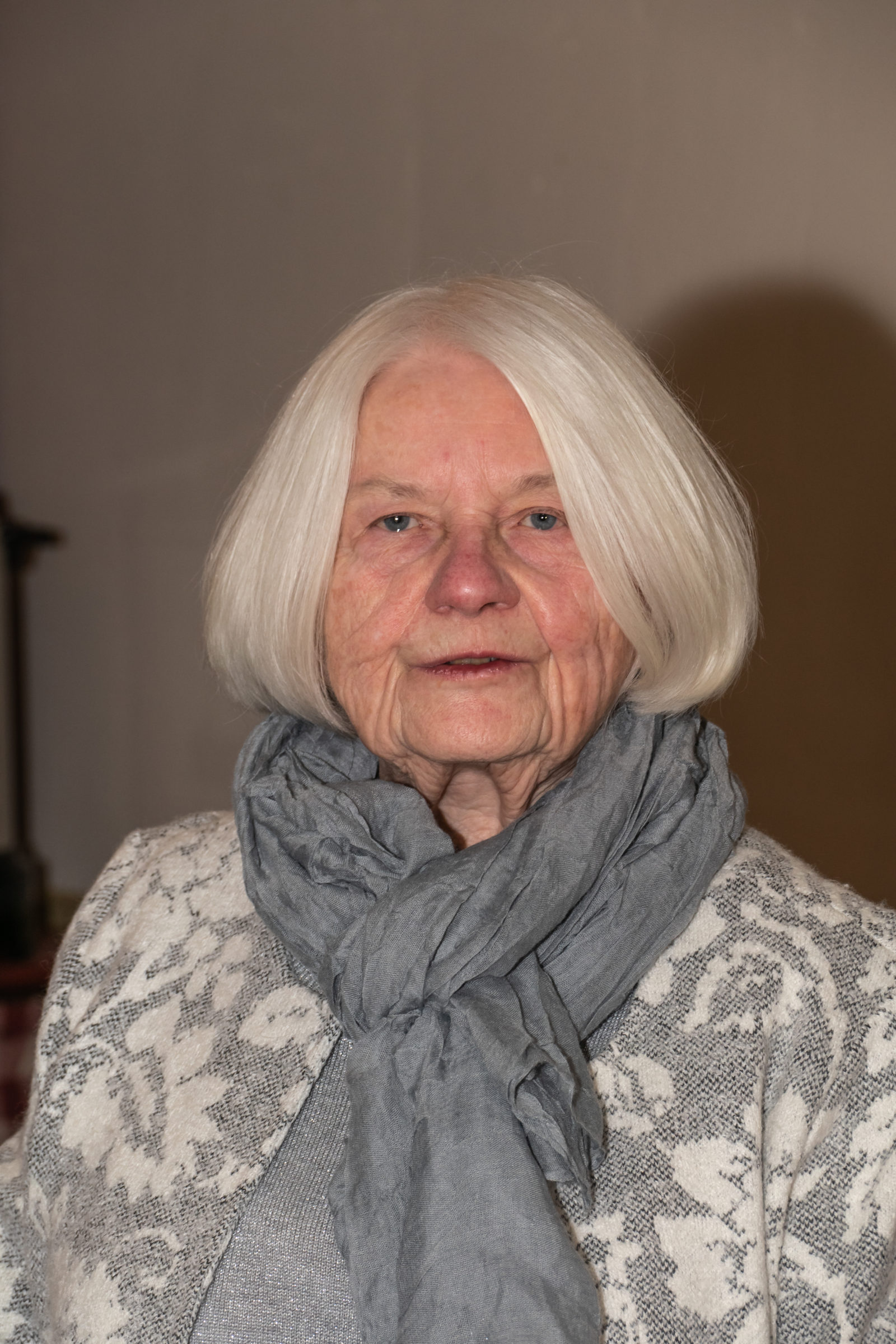 Elderly woman with white hair and scarf