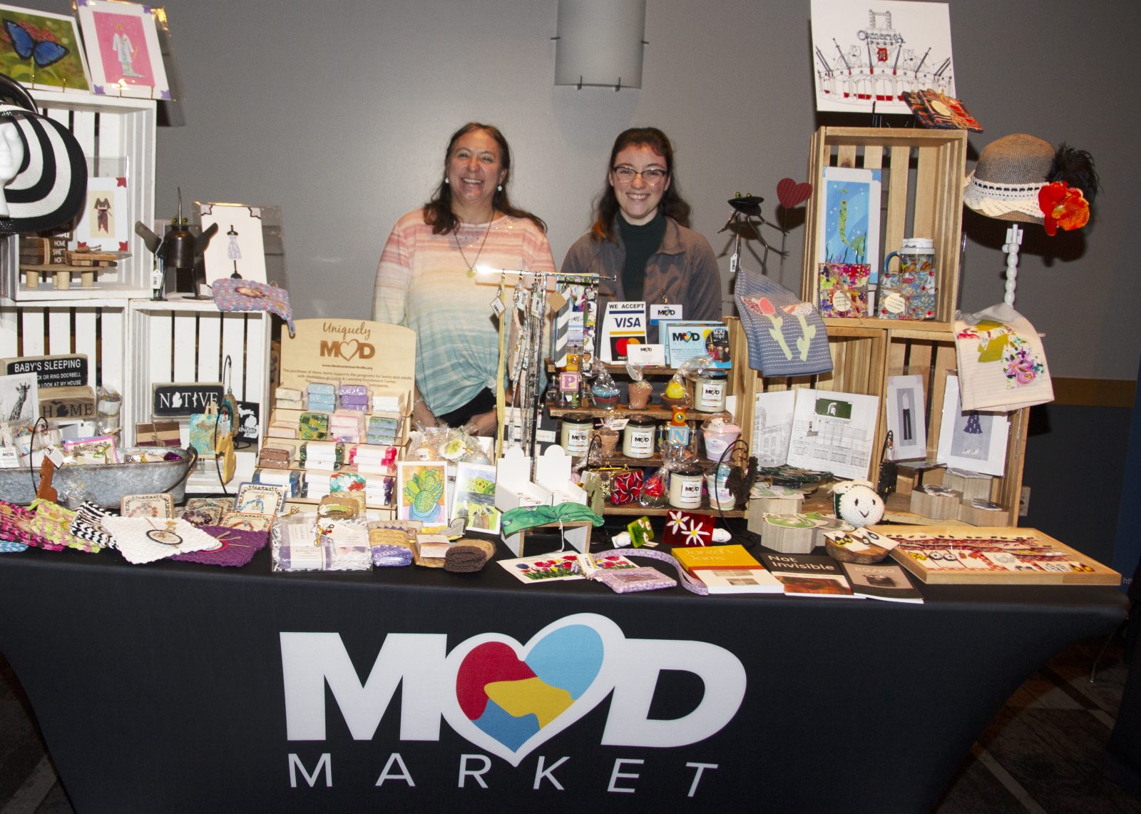 Two vendors behind Mood Market craft table